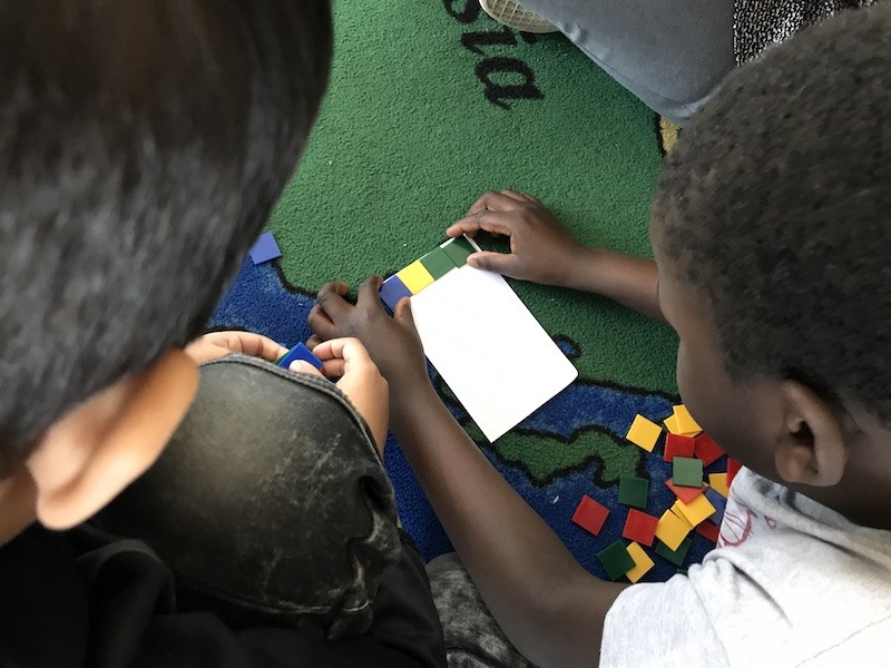 Sometimes concrete is not enough - students arranging a row of 4 square tiles copy